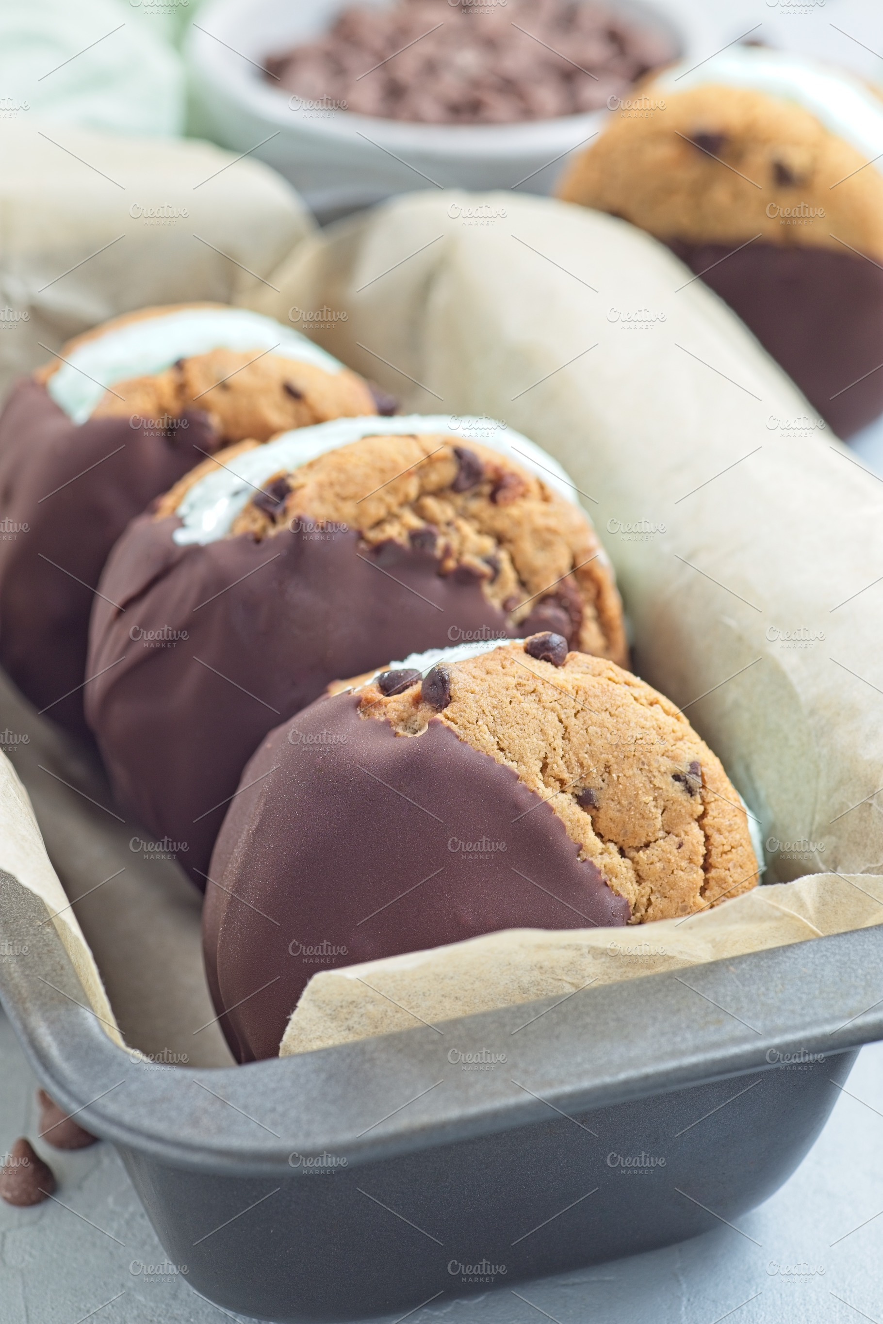 Mint chocolate chips ice cream and chocolate chips cookies sandwiches, vertical, a Food & Drink Photo by iuliia_n