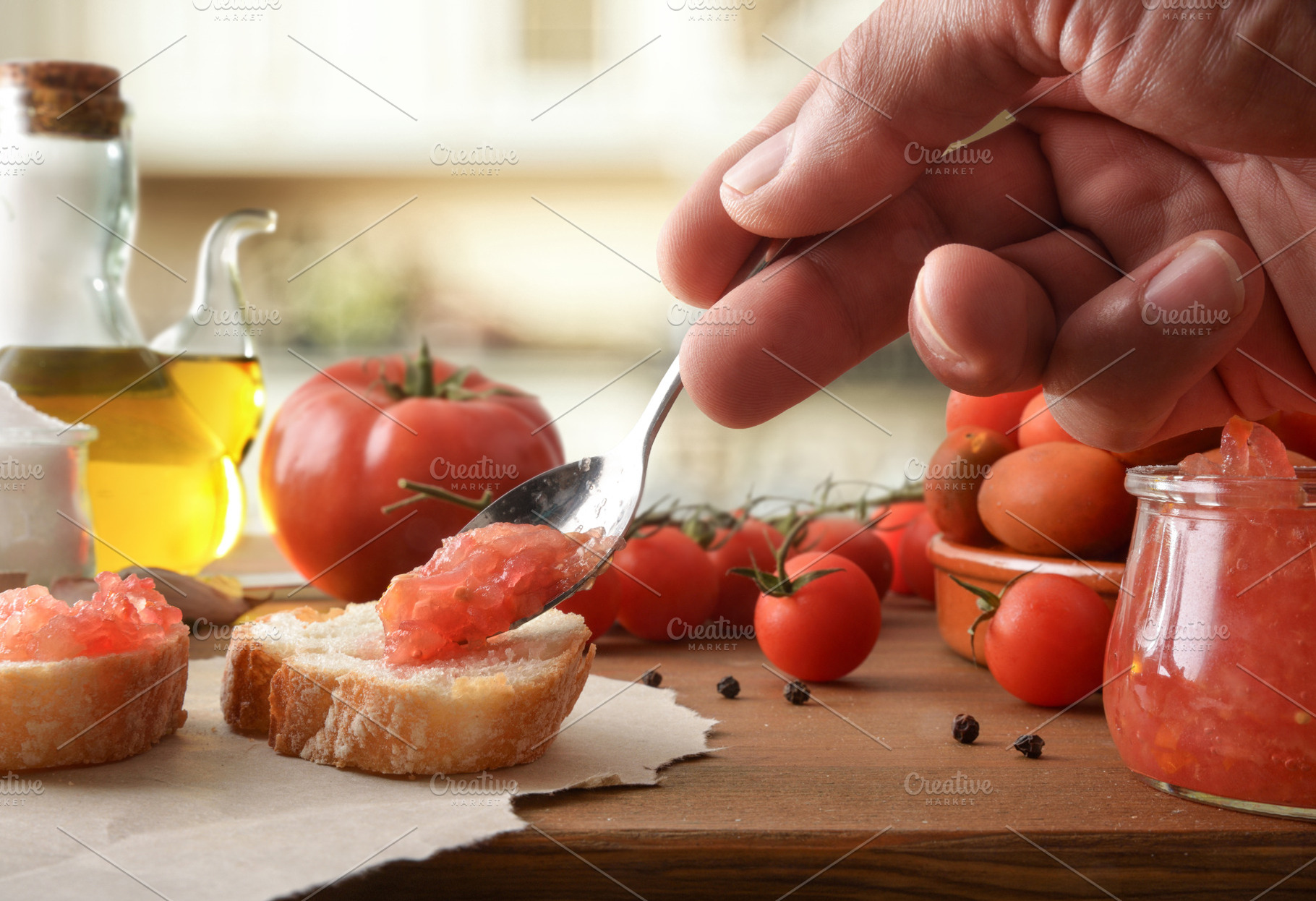 Hand Spreading Tomato Topping on Rustic Toast, a Food & Drink Photo by Davizro's Market