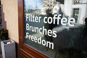 Filter coffee, brunches, freedom. Cafe window with filter coffee sign reflectin, a Photo by AS photostudio