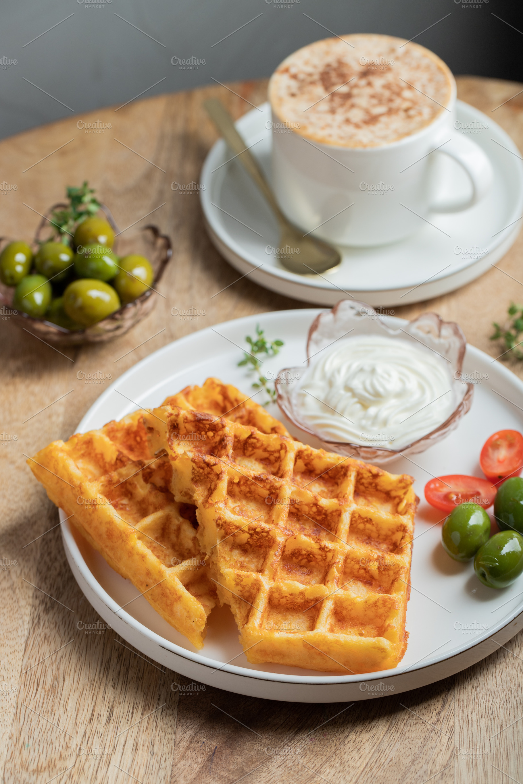 Crunchy waffle fries with sour cream dip served in a basket, a Food & Drink Photo by Budarinphoto