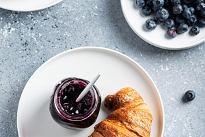 Croissant and blueberry jam containing bakery sweets, bakery shop, and france