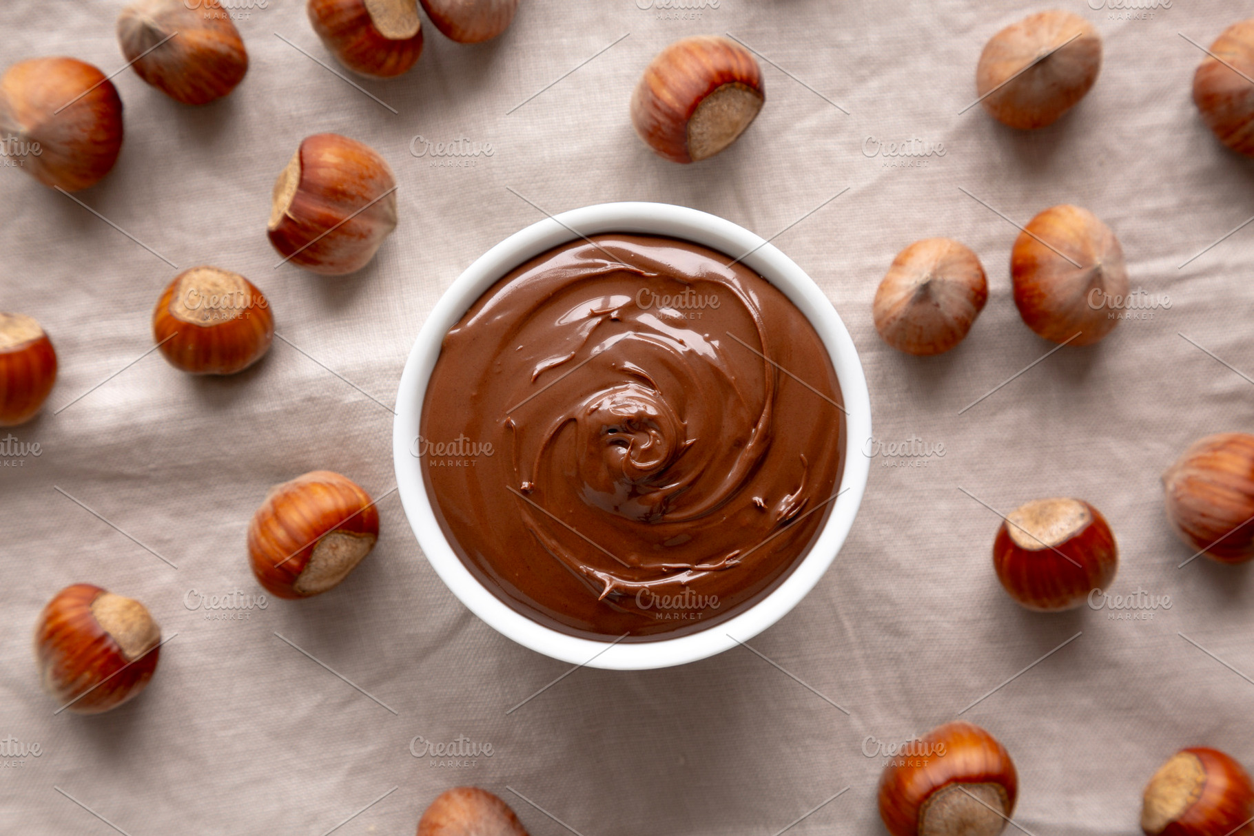 Homemade Chocolate Hazelnut Spread in a Bowl, top view., a Food & Drink Photo by LiudmylaChuhunova