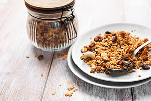 Healthy homemade granola mix on plate with spoon, a Food & Drink Photo by Olena Rudo