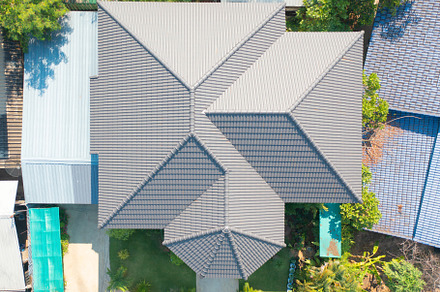 Aerial top view of white double corrugated tiles on roof home or, a Background Photo by Tampatra