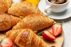 Delicious french breakfast with croissants, coffee, strawberries, a Food & Drink Photo by Olena Rudo