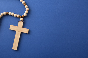 Wooden Cross Necklace on Blue Background, a Holiday Photo by Davizro's Market