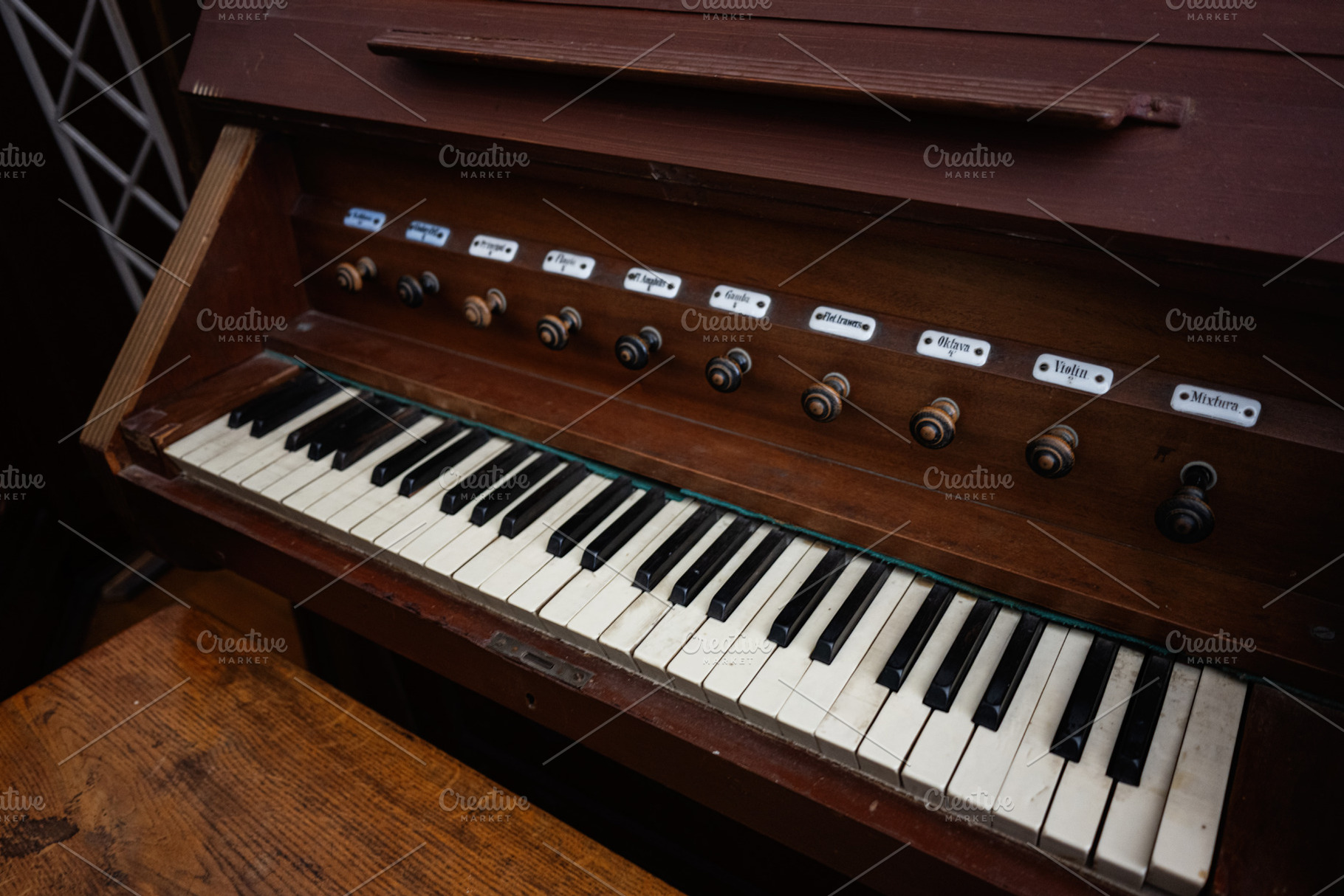 Antique wooden keyboard instrument with labeled stops and detailed craftsmanshi, a Photo by AS photostudio