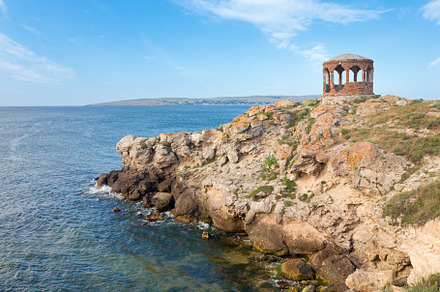 Rocky summer coastline and cape with pavilion, a Nature Photo by YuriyB
