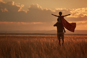 Father and son playing superhero sun, a Photo by Pixeness Studio