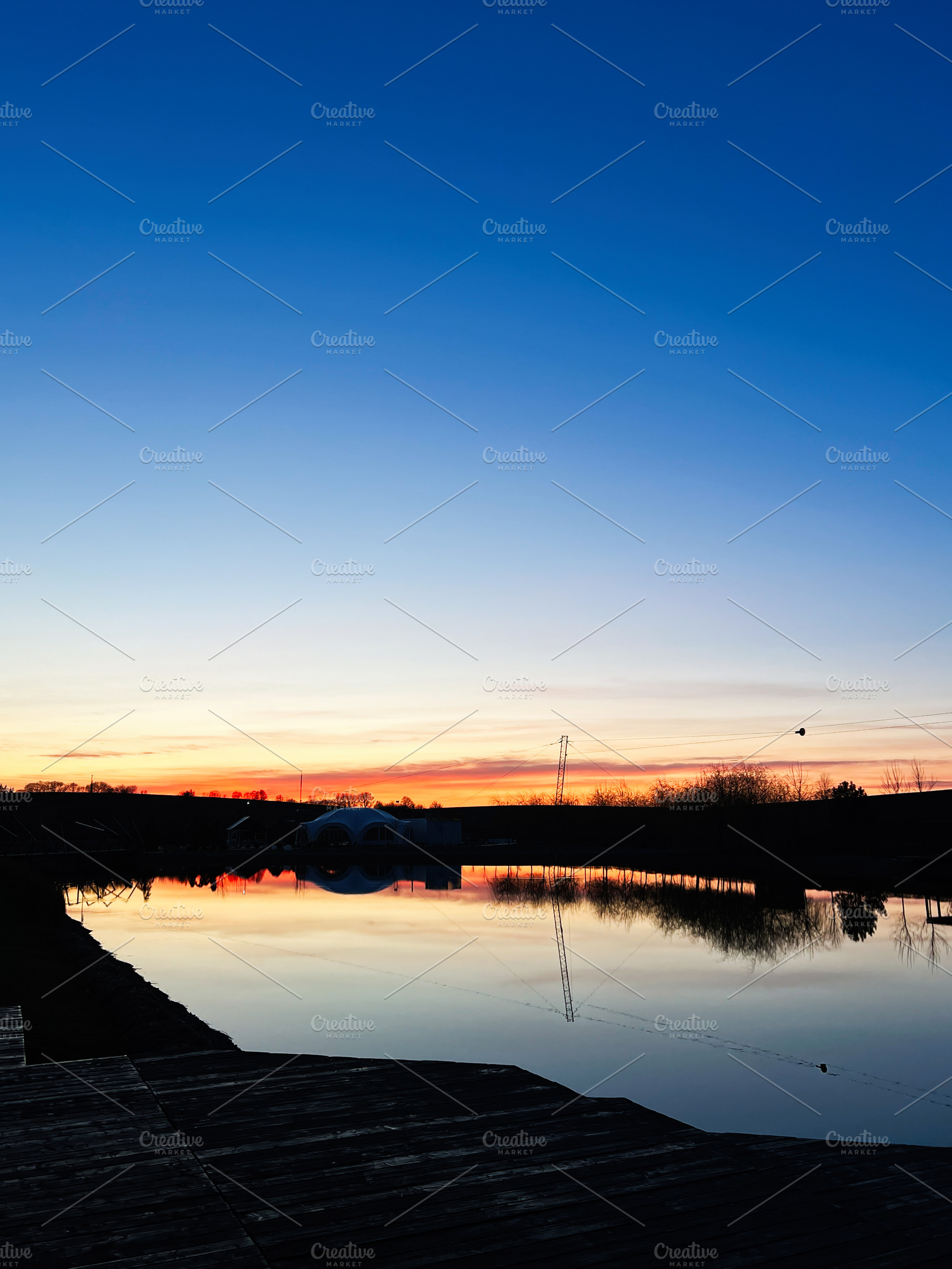 Scenic sunset over a still water lake with a vibrant sky reflection, a Photo by AS photostudio