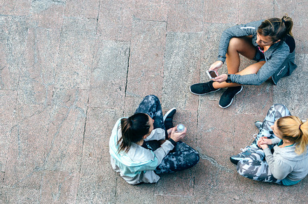 Women friends runners relaxing sitting on the floor after training, a Sports & Recreation Photo by davidpereiras