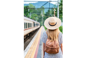 Young Woman Waits for Train Wearing, a Transportation Photo by Lermont51