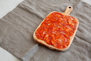 Cold Meat Chorizo Slices on a Wooden Board, side view. Copy spac, a Food & Drink Photo by LiudmylaChuhunova