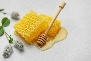 Honeycombs, honey dipper and mint flowers creating a sweet and n, a Food & Drink Photo by Olena Rudo