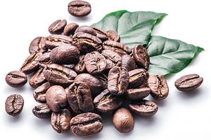Roasted coffee beans and leaves on white background., a Food & Drink Photo by Volff