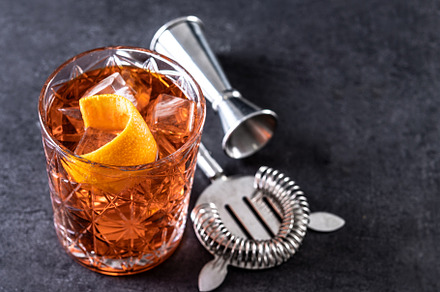 Americano cocktail garnished with twist orange on black slate background, a Food & Drink Photo by etorres69