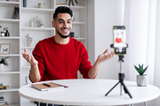 Young Arab Male Blogger Recording Video At Home With Smartphone On Tripod, a Photo by Prostock-Studio (Thumbnail 2 of 2)