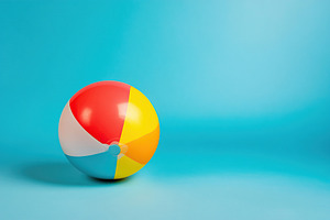 Colorful beach ball resting on pastel blue background enhances summer vibes and, a Sports & Recreation Photo by AlyaAnd