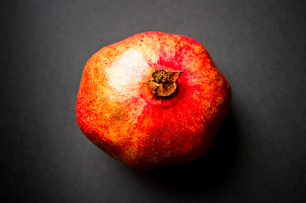 Pomegranate isolated on black background, a Food & Drink Photo by GoodGoods
