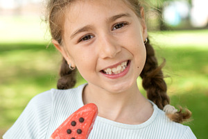 Smiling Little Girl Holding a Watermelon Popsicle, a Person Photo by etorres69