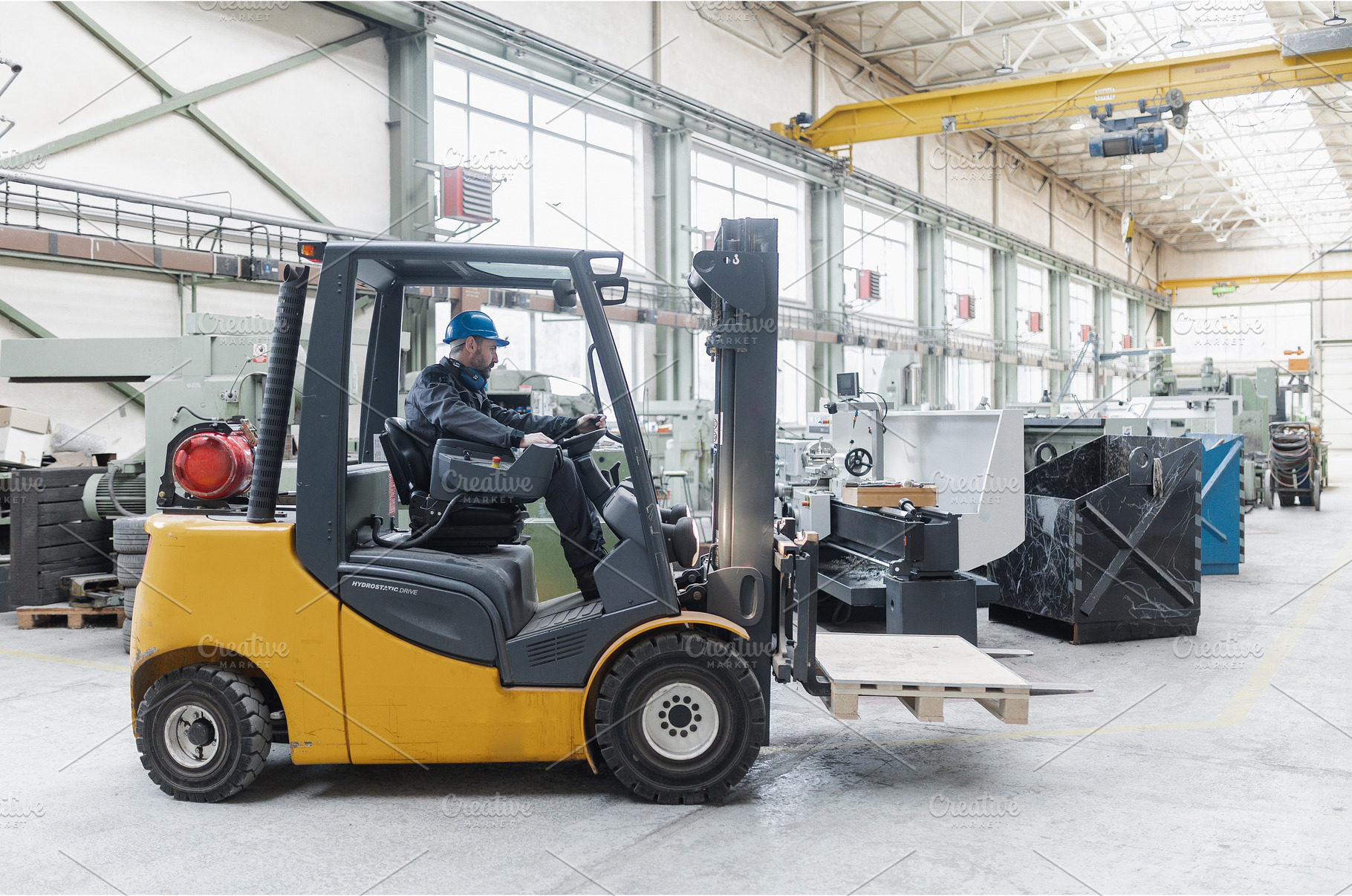 Happy mature man fork lift truck, an Industrial Photo by HalfPoint