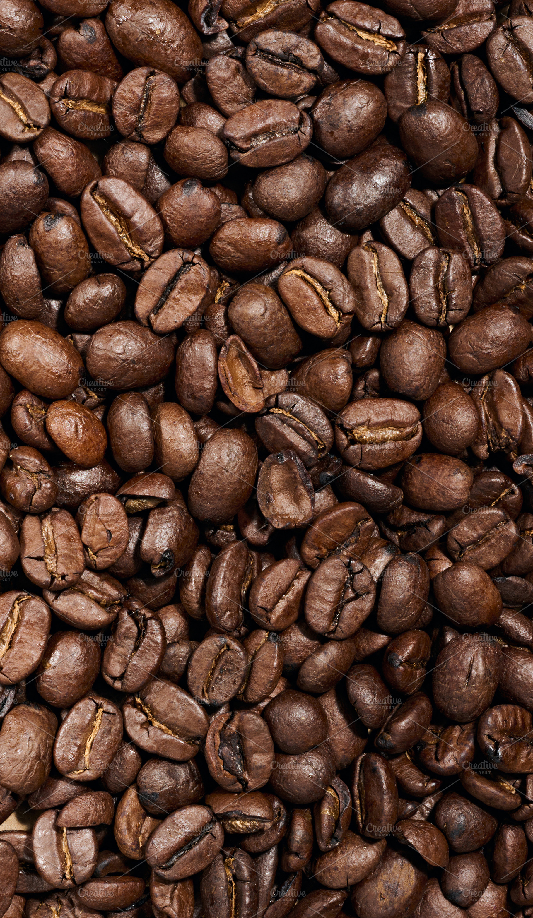 Whole roasted coffee beans scattered chaotically, a Food & Drink Photo by ndanko