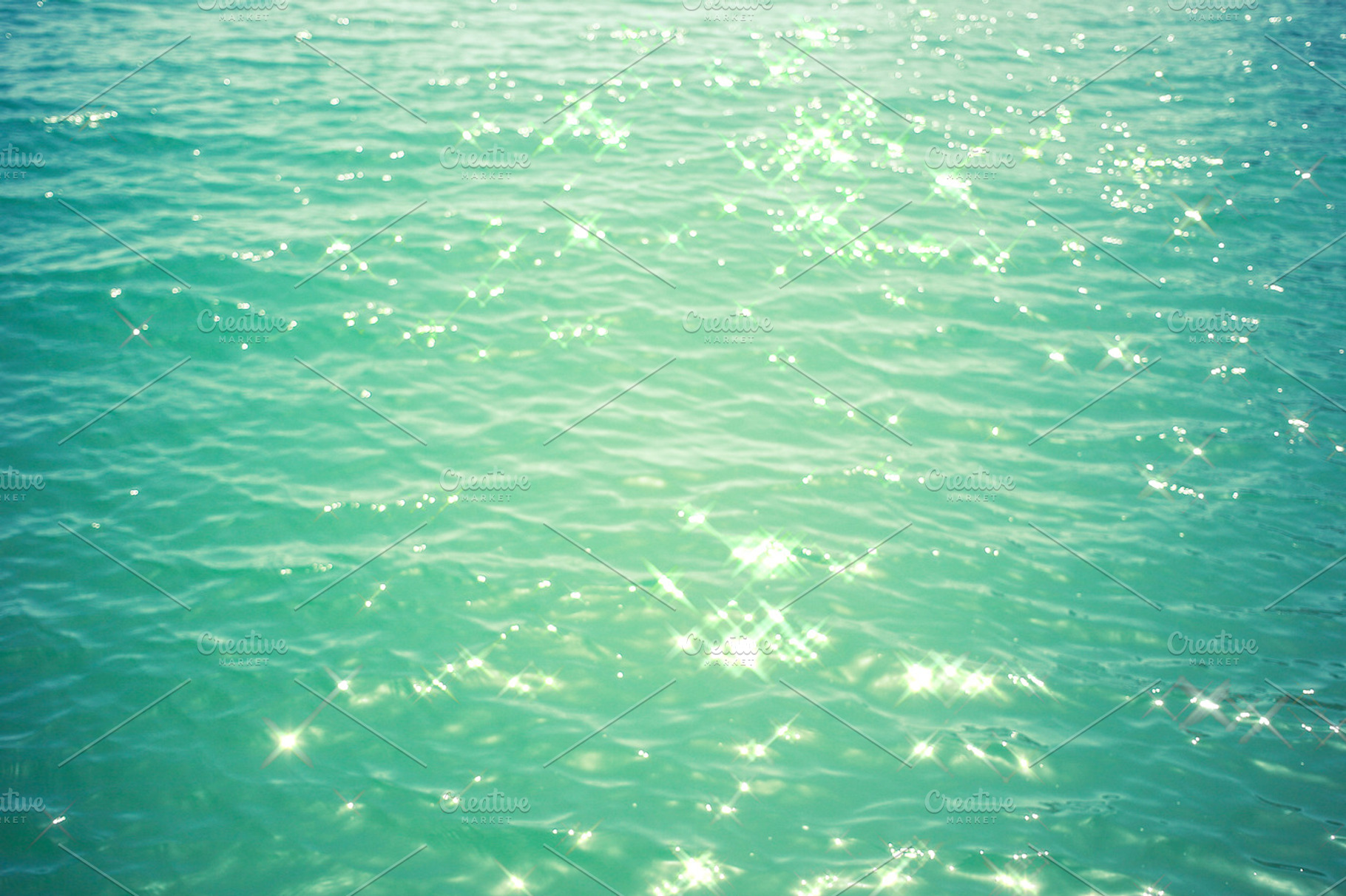 Sea background - turquoise water with glare of light, a Nature Photo by PSD templates and Photos
