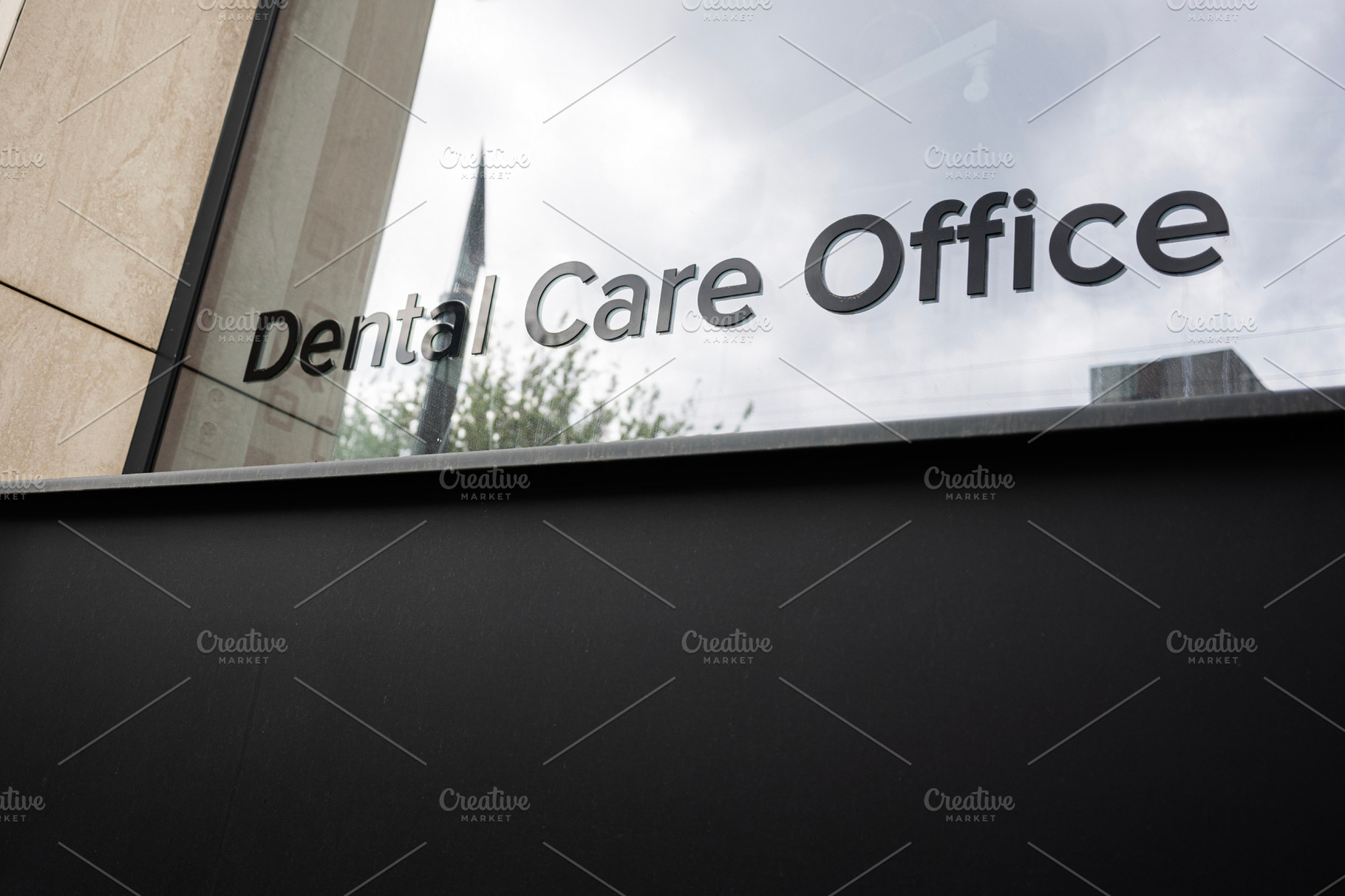Exterior view of a dental care office building with reflective glass windows, a Photo by AS photostudio
