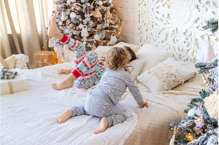Children jump on the bed near the, a Person Photo by yanadjana