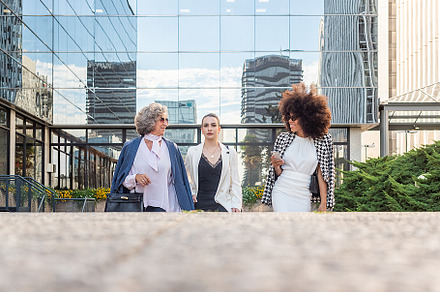 three business women leaving work talking to each other, a Business Photo by Iván Moreno STOCK PHOTO