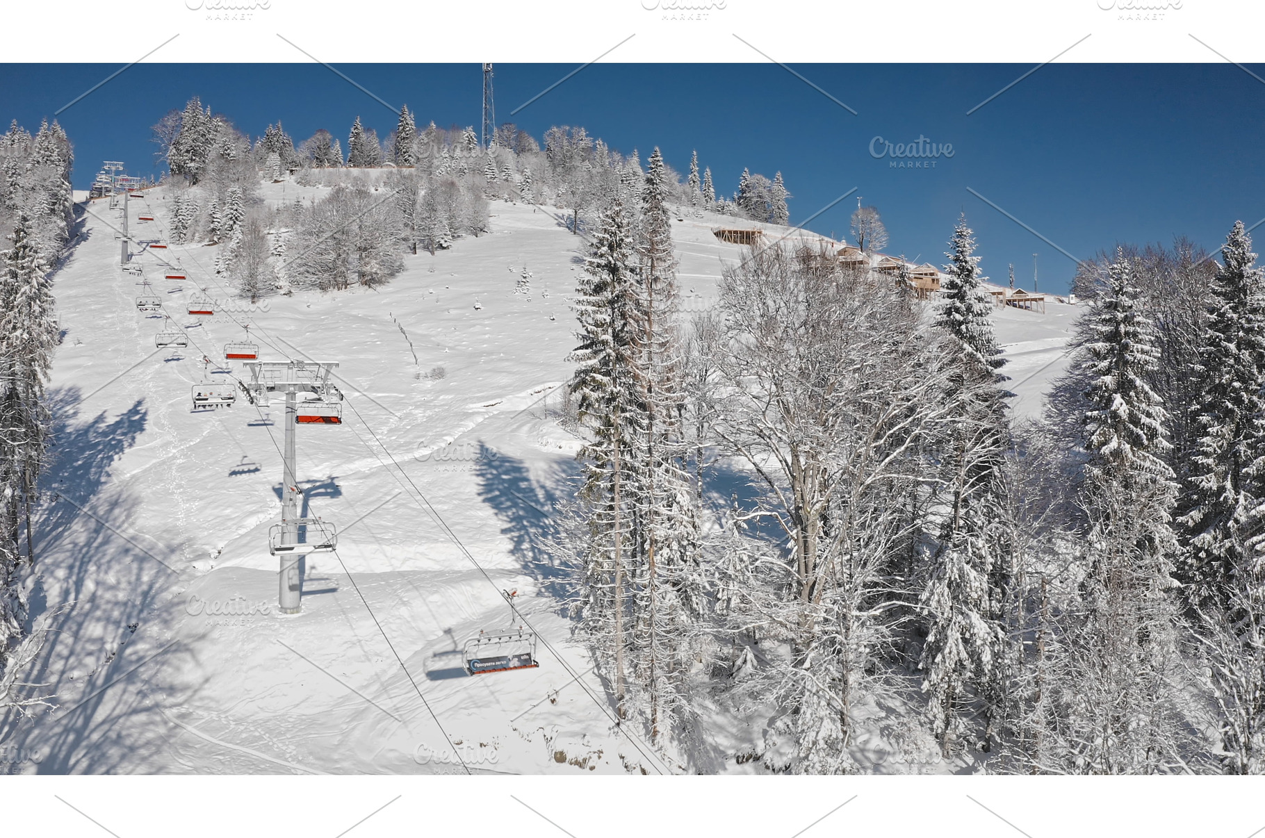 Ski lift ascending snowy mountain, a Nature Photo by Goinyk