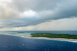 Aerial view of Tikehau atoll, French Polynesia, with cloudy sky, a Nature Photo by GoodGoods