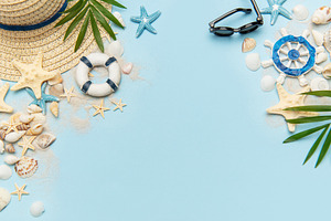 Summer vacation accessories creating a frame on blue background, a Holiday Photo by Olena Rudo