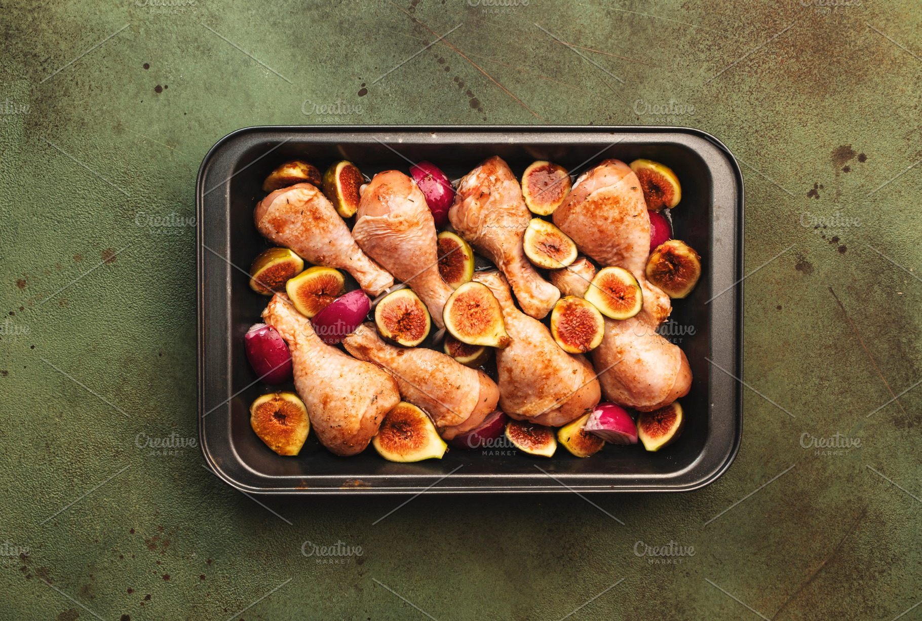 Raw chicken legs, drumsticks with sweet figs and red onions in b, a Food & Drink Photo by 5PH
