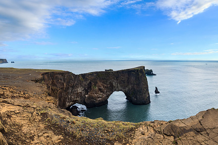 Picturesque autumn evening view to Dyrholaey coast cliffs and ro, a Nature Photo by YuriyB