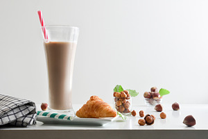 Hazelnut drink on table and croissant with white isolated backgr, a Food & Drink Photo by Davizro's Market