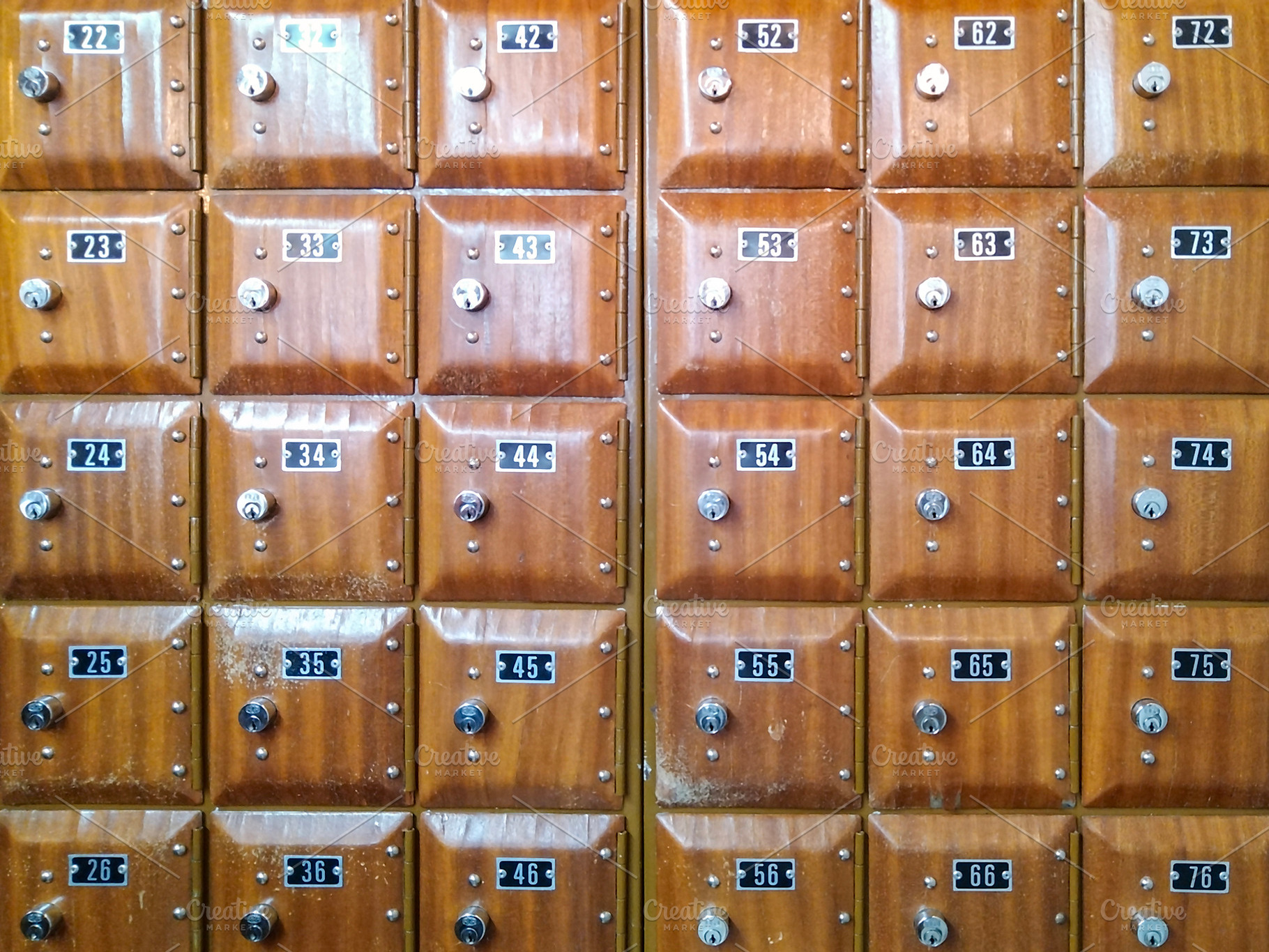 Grid of wooden mailboxes with metal locks, an Industrial Photo by DanFLCreativo