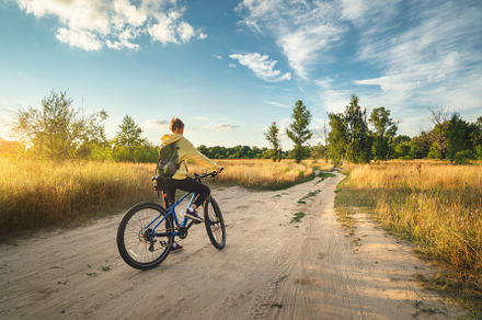 Woman riding a mountain bike in cross country road in summer, a Sports & Recreation Photo by den-belitsky