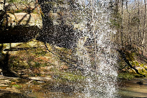 Waterfall in Indiana park with rocky ledge, spray, and clear blue sky, a Photo by AS photostudio