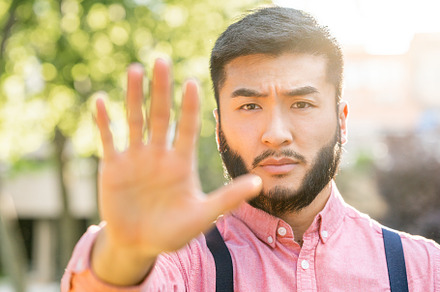 Asian man in casual clothes gesturing stop with the hand, a Business Photo by Iván Moreno STOCK PHOTO