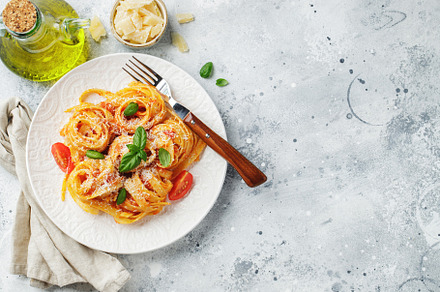 Tasty appetizing classic italian tagliatelle pasta with tomato sauce, cheese pa, a Food & Drink Photo by Budarinphoto