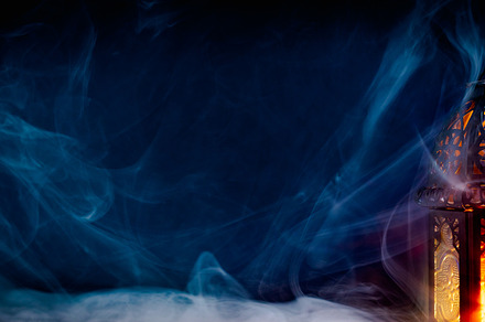 Ramadan Kareem banner design with lantern on dark blue background with smoke. E, a Holiday Photo by photoguns