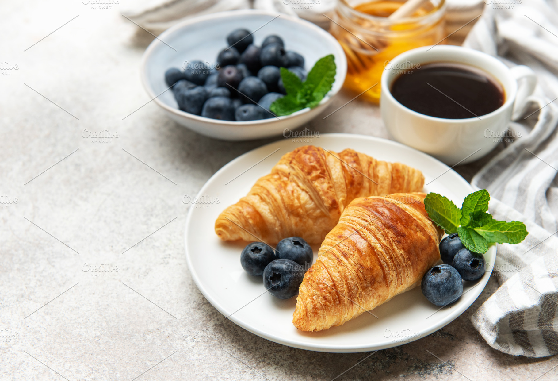 Delicious french breakfast with croissants, coffee, honey and fr, a Food & Drink Photo by Olena Rudo