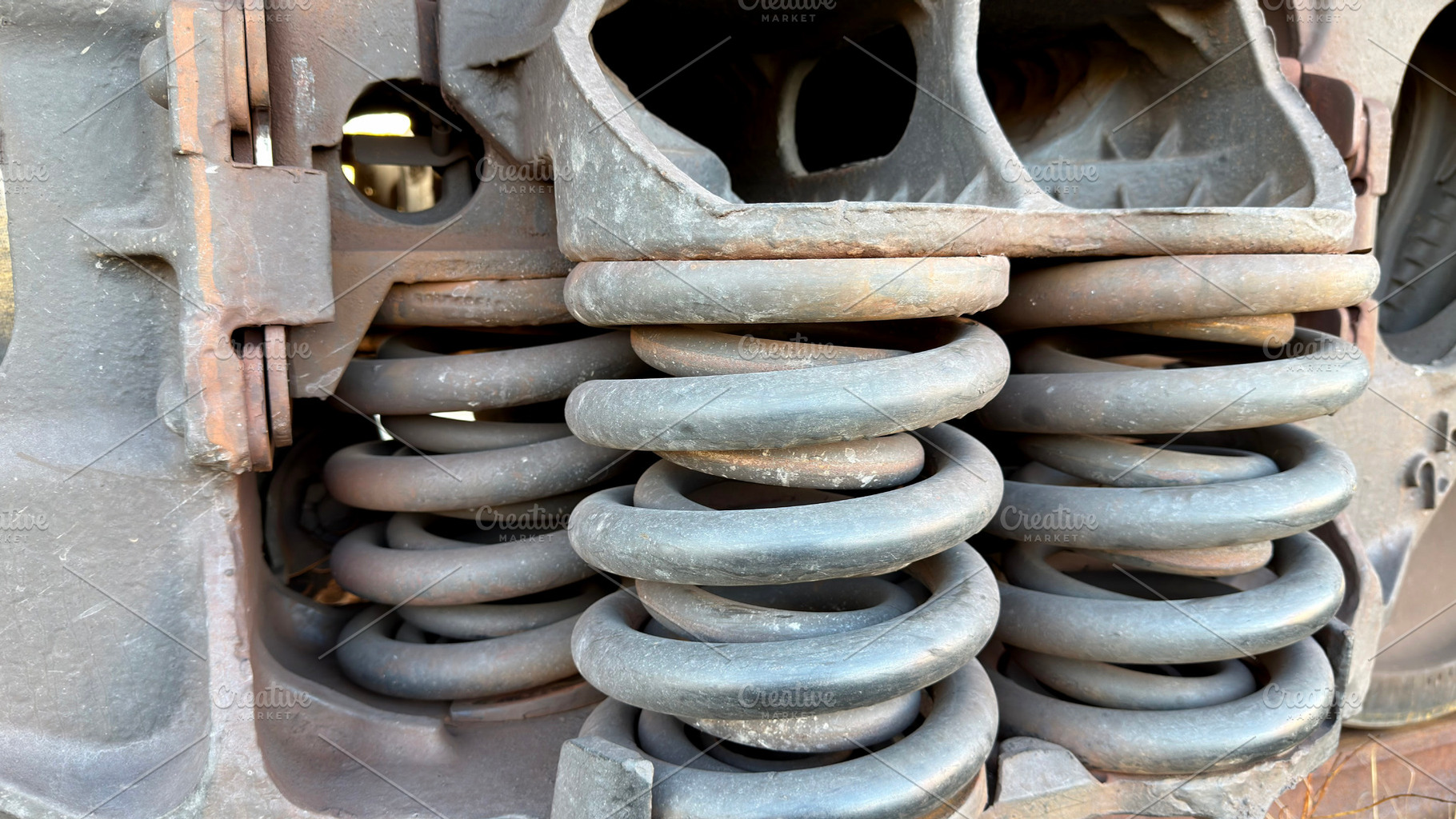 Close-up of metal springs and machinery components, showcasing rust and wear, an Industrial Photo by Textures & Backgrounds