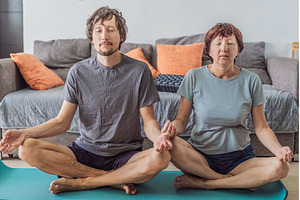 Older woman meditating on a yoga mat, a Person Photo by Elizaveta Galitskaya
