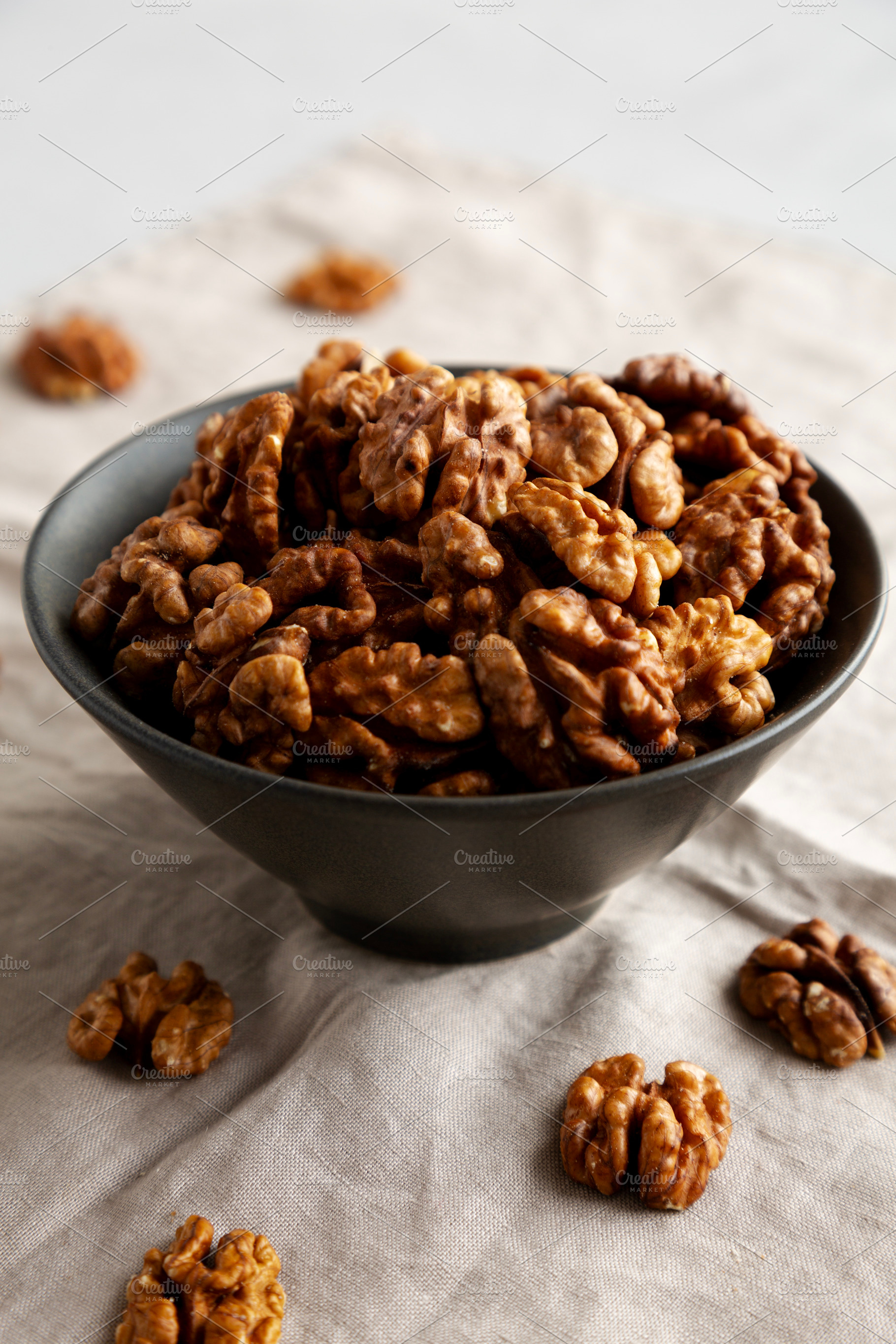 Raw Walnut Halfs in a Bowl, side view., a Food & Drink Photo by LiudmylaChuhunova