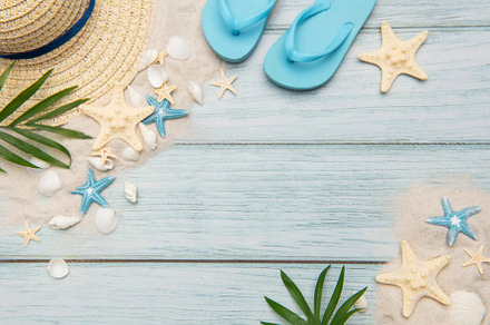 Summer accessories on blue wooden planks evoking beach holidays,