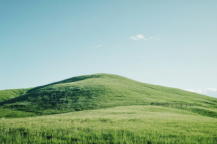 Vast green hill with guardrail under, a Photo by Iftikhar Alam