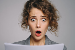 Woman shows surprise while reading, a Photo by Beautiful things