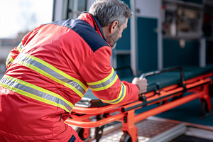 Loading stretcher into ambulance